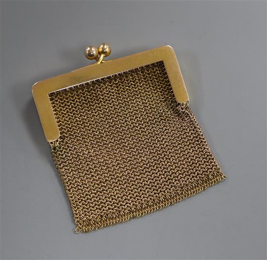 A small 14k yellow metal mesh purse.